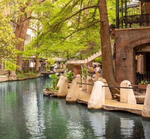 San Antonio Marketing Services A water canal leading through San Antonio during the day.